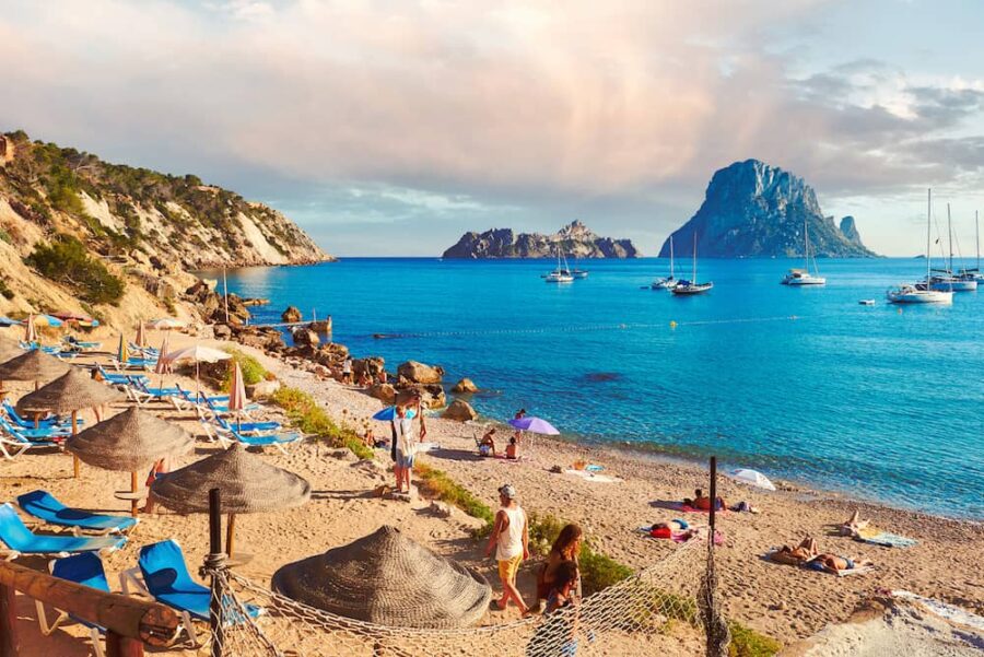 Tourists relaxing on a beautiful beach in Ibiza